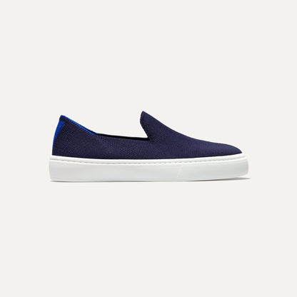 side | The Kids slip-on Sneaker in Deep Navy shown from a side view showing the outsole.