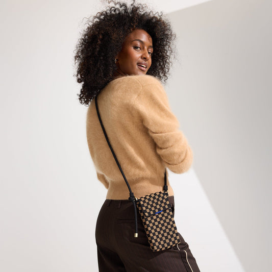 hover | A model wearing The Phone Crossbody in Midnight Song.