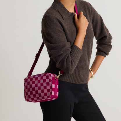 hover | Model wearing The Crossbody Camera Bag in ReVelvet™ Orchid, shown from the front.